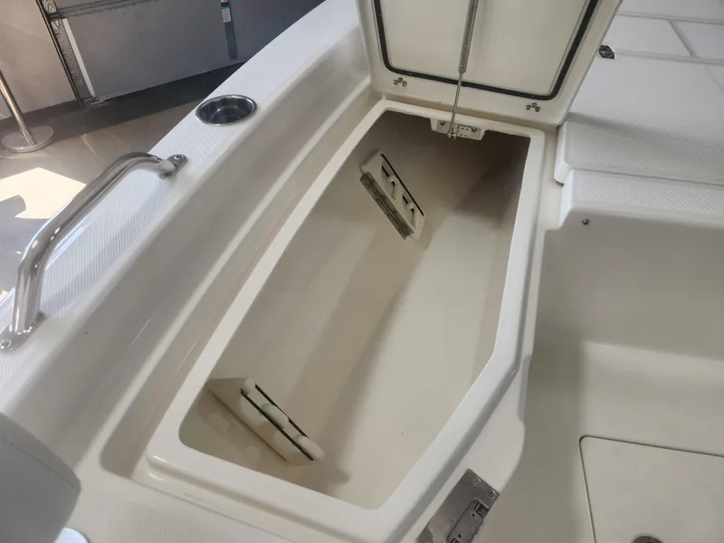 Slide: The Image of Open storage compartment on 2025 Pathfinder 2200 TRS boat, showcasing interior space. - 13