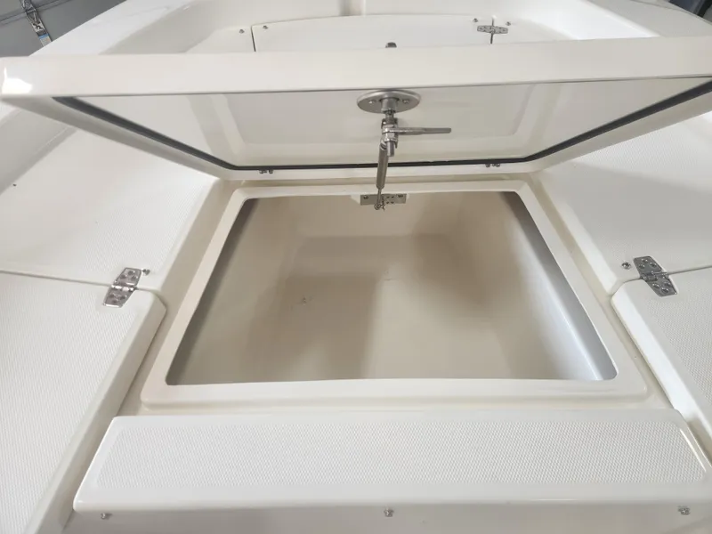 Slide: The Image of Open storage compartment on 2025 Pathfinder 2200 TRS boat, showcasing interior space. - 15