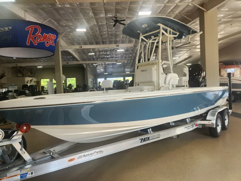 Slide: The Image of 2025 Pathfinder 2200 TRS boat on trailer in showroom. - 2