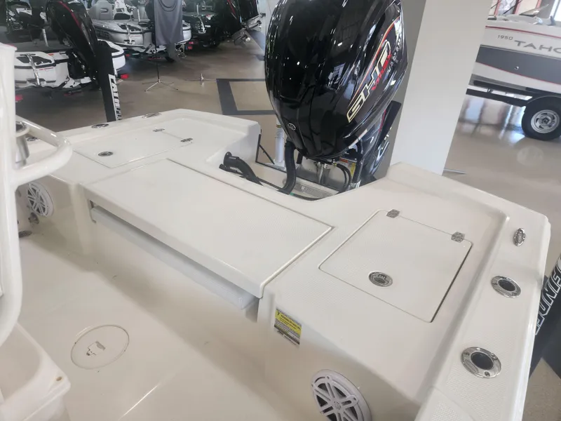 Slide: The Image of 2025 Pathfinder 2200 TRS boat with outboard motor in showroom setting. - 21