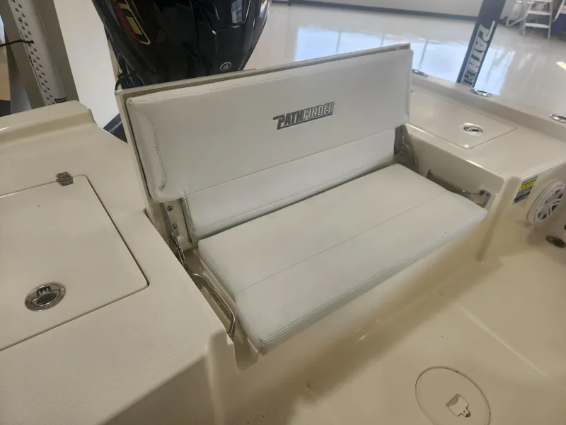 Slide: The Image of 2025 Pathfinder 2200 TRS boat seat with white upholstery and storage compartment. - 22