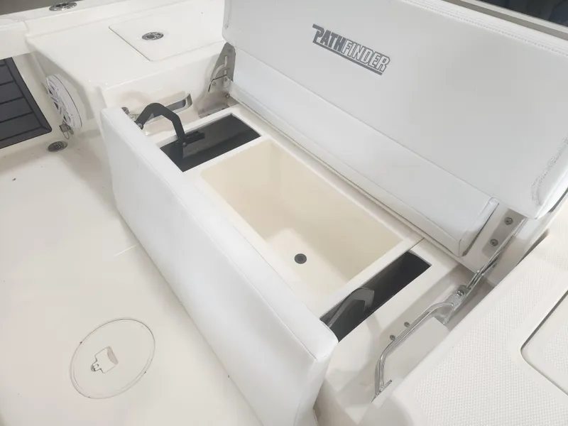 Slide: The Image of 2025 Pathfinder 2200 TRS boat with open storage compartment and seating. - 23