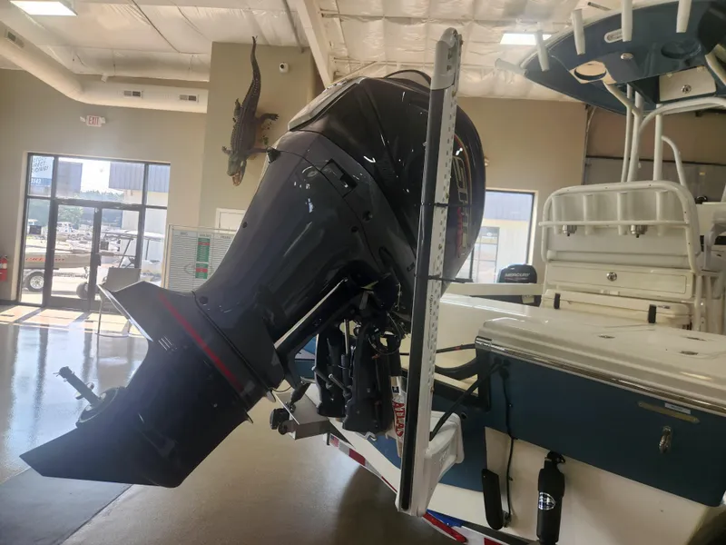 Slide: The Image of 2025 Pathfinder 2200 TRS boat with powerful outboard motor in showroom. - 6