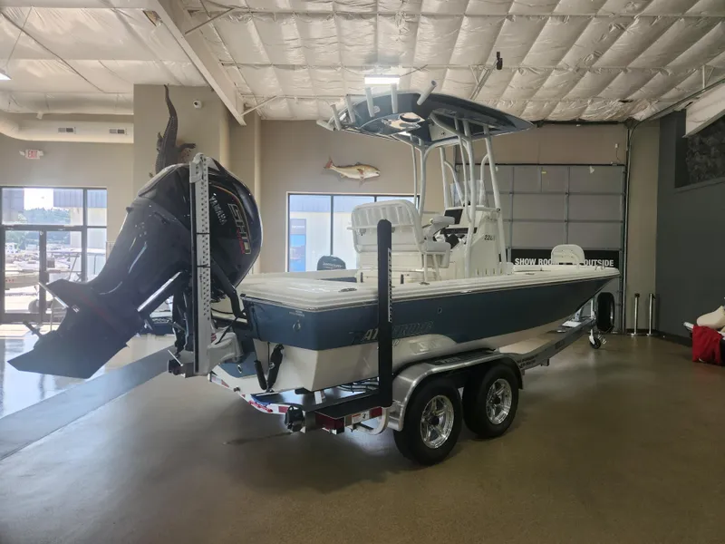 Slide: The Image of 2025 Pathfinder 2200 TRS boat in showroom, featuring powerful outboard motor. - 7