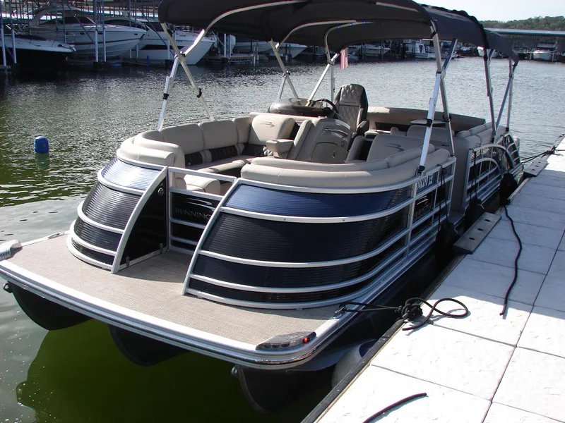 Slide: The Image of 2019 Bennington Q 25 QSBIO pontoon boat docked at a marina. - 20