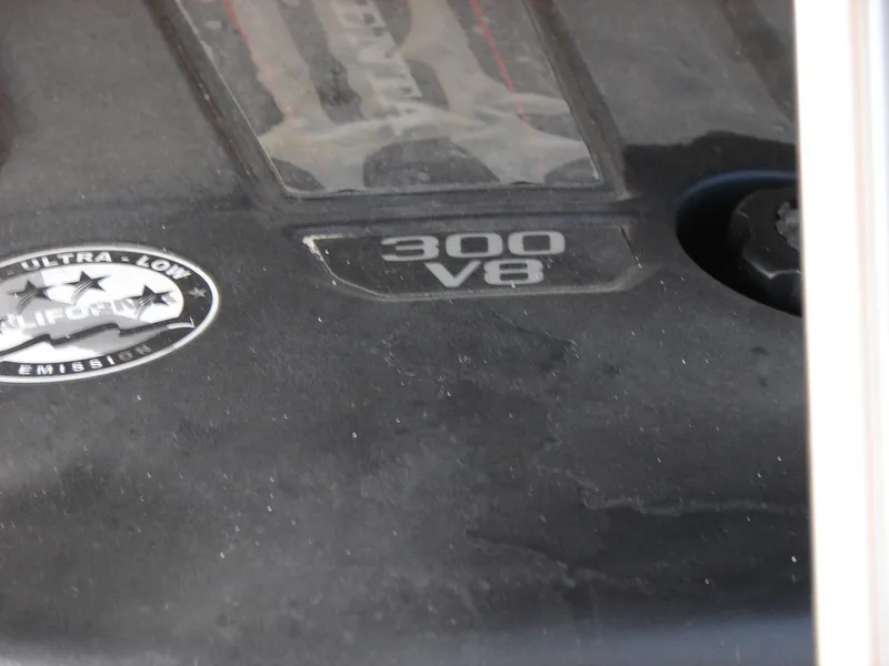 Slide: The Image of Close-up of a 2019 Bennington Q 25 QSBIO engine cover, featuring "300 V8" and emission badge. - 24