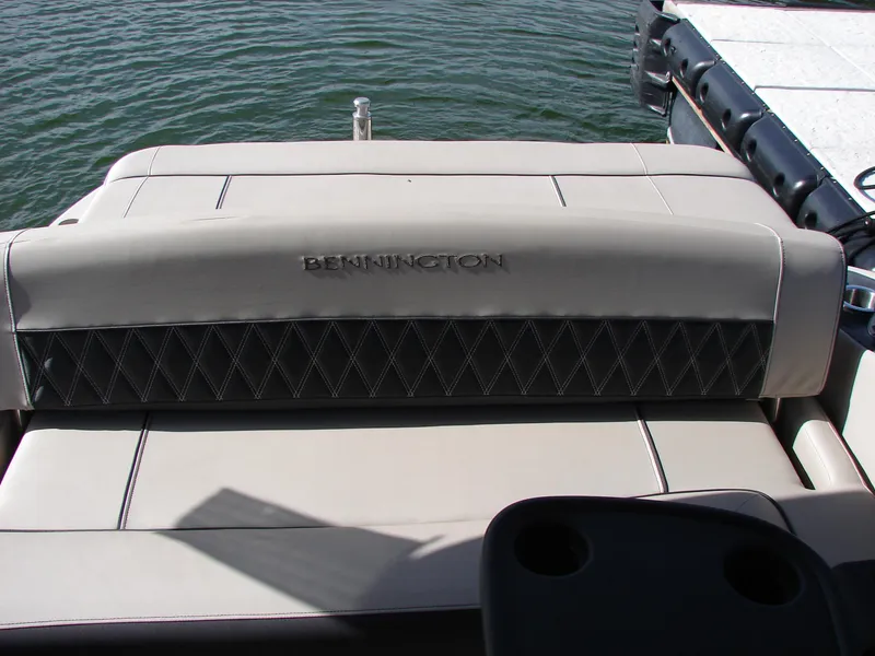 Slide: The Image of 2019 Bennington Q 25 QSBIO boat seat with diamond stitching, docked by water. - 29