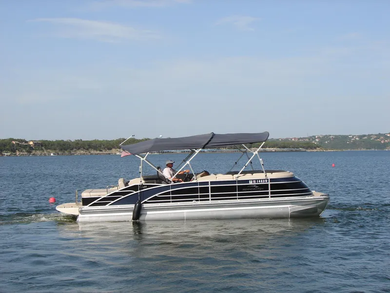 Slide: The Image of 2019 Bennington Q 25 QSBIO pontoon boat cruising on a lake. - 7