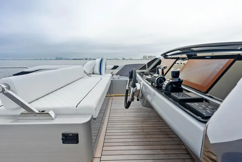 Slide: The Image of Riva 88' FOLGORE 2021 yacht helm station with modern controls and white seating. - 23