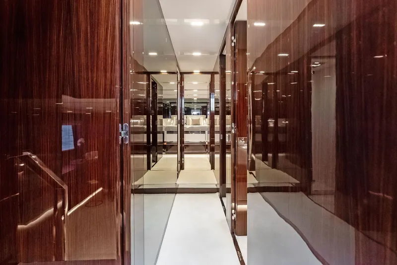 Slide: The Image of Luxurious interior hallway of 2021 Riva 88' FOLGORE yacht with glossy wood finish. - 36