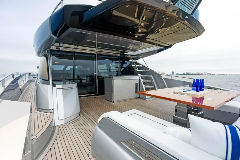 Slide: The Image of Luxury deck of 2021 Riva 88' FOLGORE yacht with modern seating and dining area. - 7