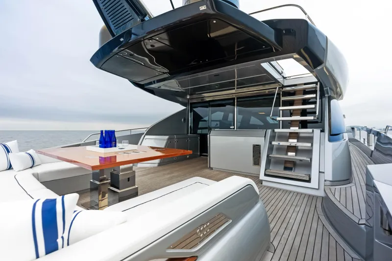 Slide: The Image of Luxury deck of 2021 Riva 88' FOLGORE yacht with modern seating and dining area. - 8