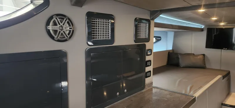 Slide: The Image of Interior of 2017 Trident Custom boat with modern design, speaker, and cozy sleeping area. - 11
