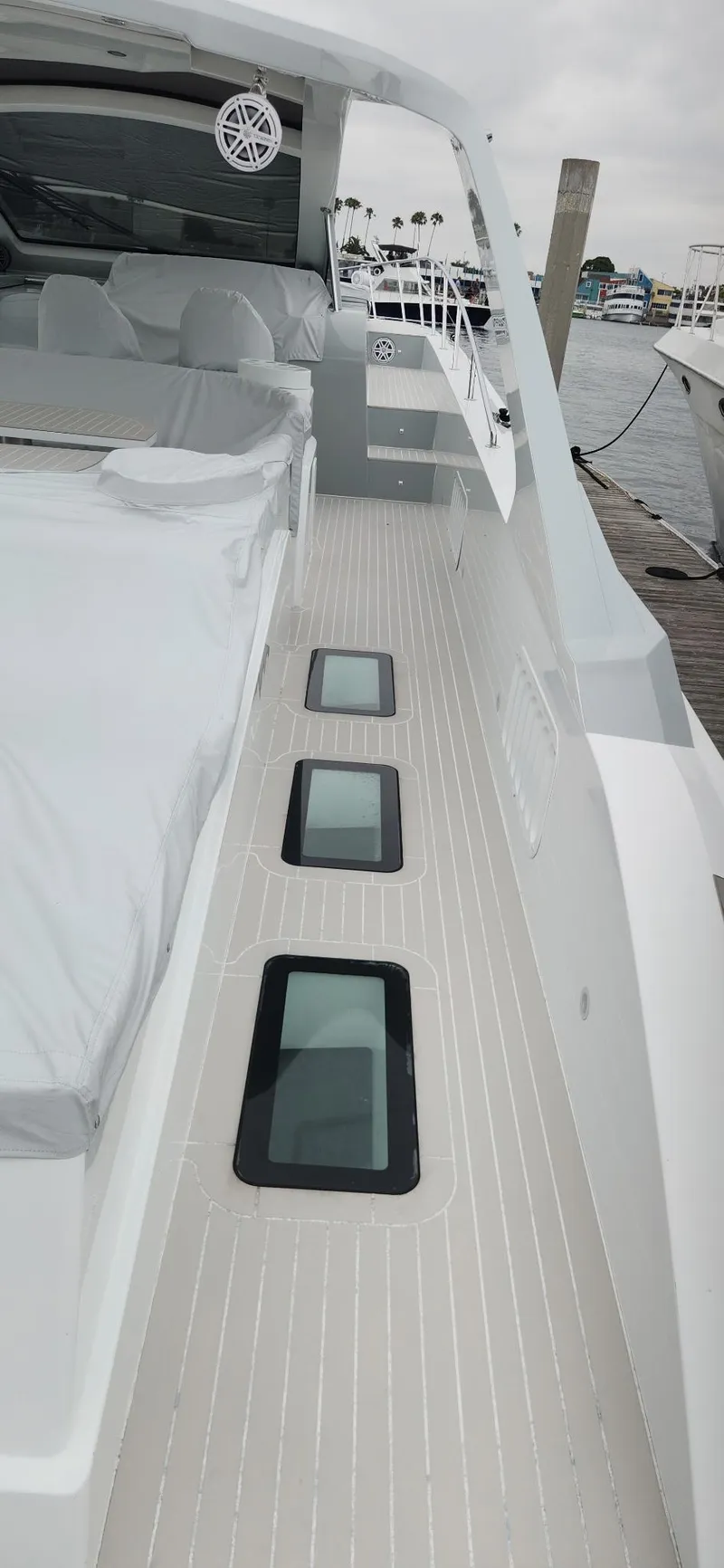 Slide: The Image of 2017 Trident Custom yacht deck with sleek design and modern windows, docked at marina. - 14