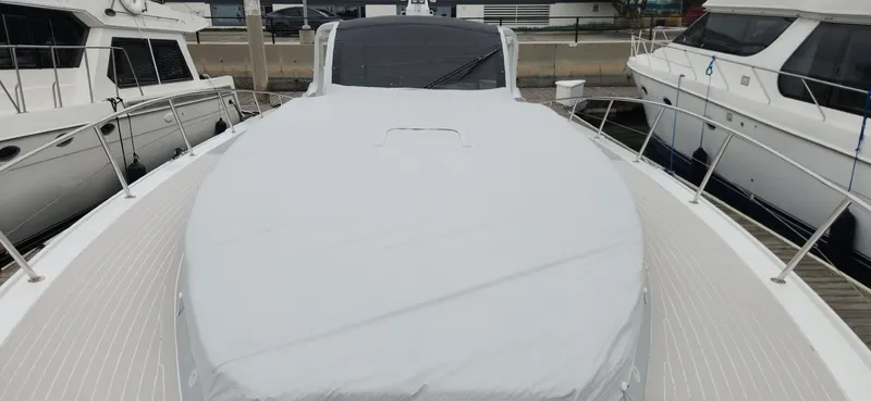 Slide: The Image of 2017 Trident Custom yacht docked at marina, covered deck, surrounded by other boats. - 17