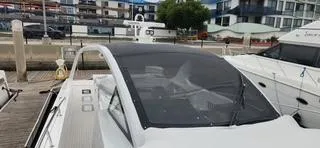 Slide: The Image of 2017 Trident Custom boat docked at a marina with modern buildings in the background. - 18