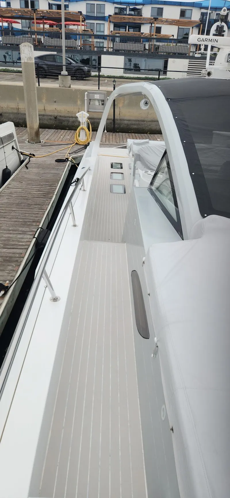 Slide: The Image of 2017 Trident Custom boat docked at marina, featuring sleek white deck design. - 19