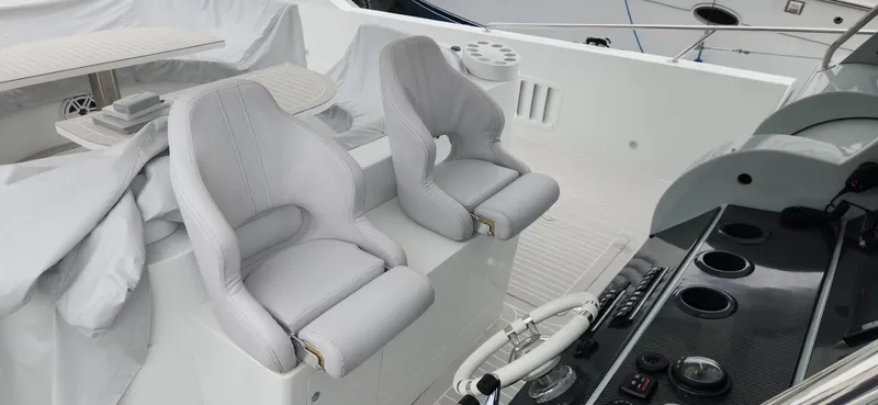 Slide: The Image of Luxury yacht cockpit with two white seats, steering wheel, and control panel, Trident Custom 2017 model. - 21