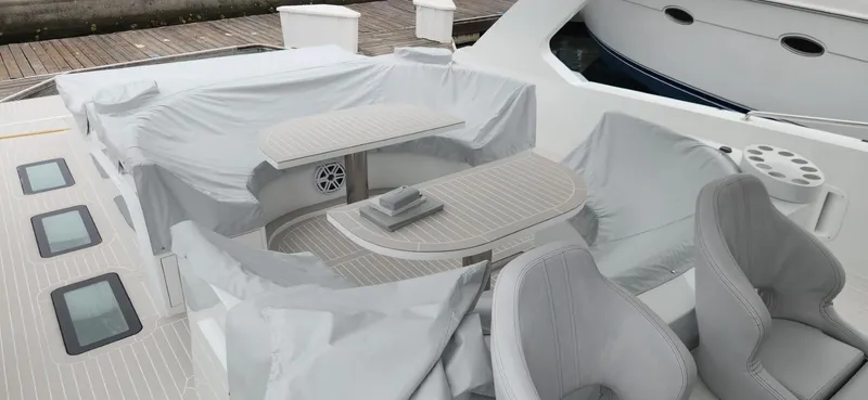 Slide: The Image of Luxurious 2017 Trident Custom yacht deck with covered seating and table, docked at marina. - 22