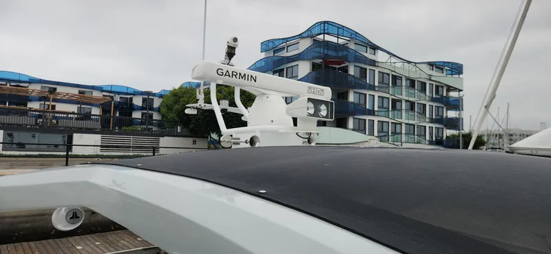 Slide: The Image of Trident Custom 2017 boat with Garmin radar, docked near modern building. - 23