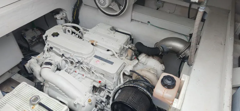 Slide: The Image of Engine compartment of a 2017 Trident Custom boat, showcasing a clean, white engine setup. - 4