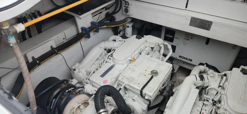Slide: The Image of Engine room of a 2017 Trident Custom boat with Kohler generator and white machinery. - 6