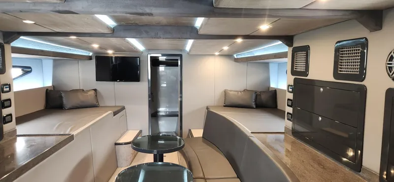 Slide: The Image of Luxurious interior of a 2017 Trident Custom boat with modern seating and entertainment area. - 7