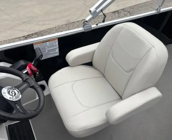 Slide: The Image of Captain's chair in 2021 Sylvan Mirage 820 Cruise boat, featuring a sleek steering wheel. - 12