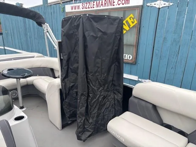 Slide: The Image of 2021 Sylvan Mirage 820 Cruise boat interior with seating and privacy curtain. - 14