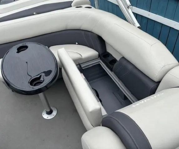 Slide: The Image of 2021 Sylvan Mirage 820 Cruise interior with seating and table, showcasing storage compartment. - 15