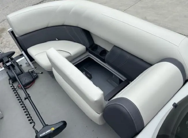 Slide: The Image of 2021 Sylvan Mirage 820 Cruise boat interior with open storage compartment and seating. - 8