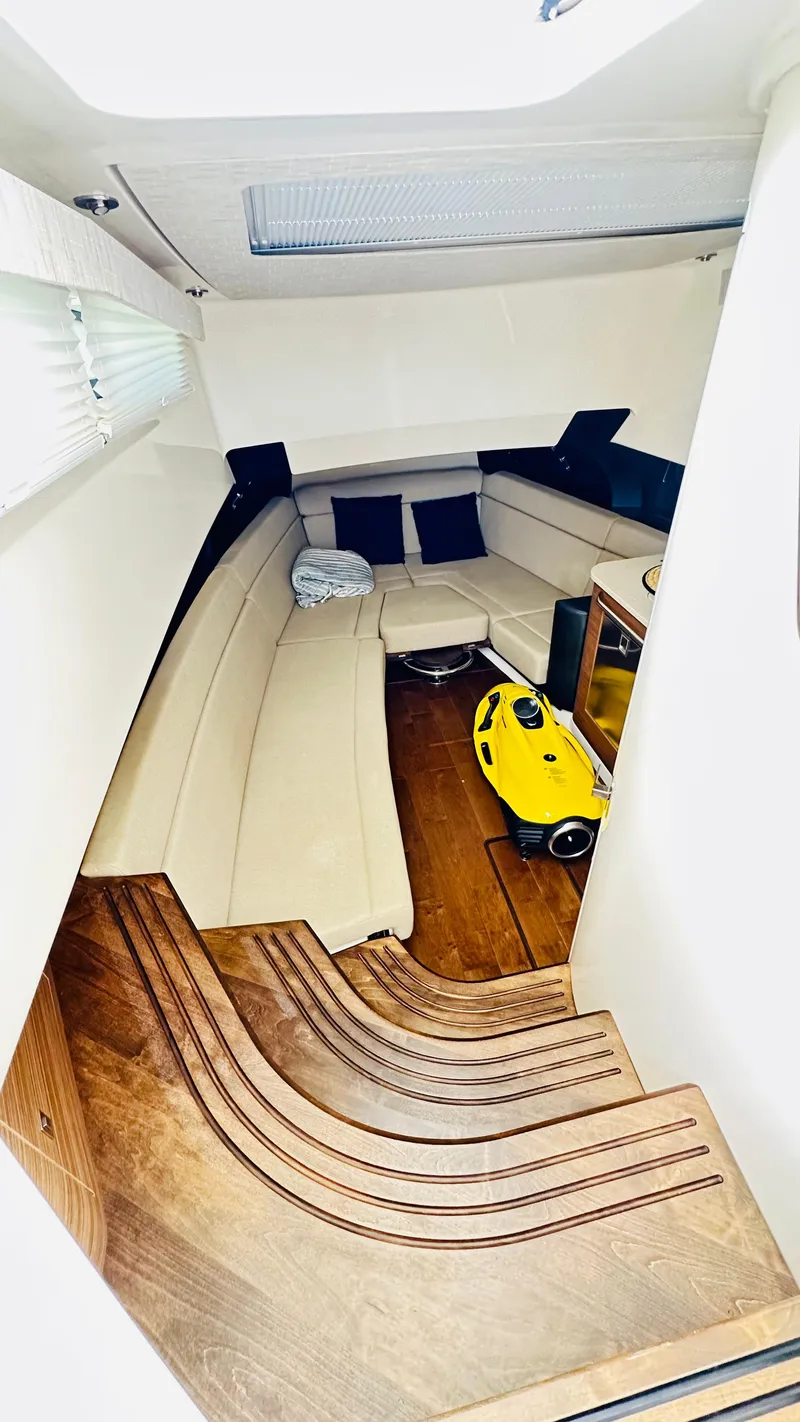Slide: The Image of Interior of 2021 Boston Whaler 420 Outrage, featuring elegant seating and wooden flooring. - 16