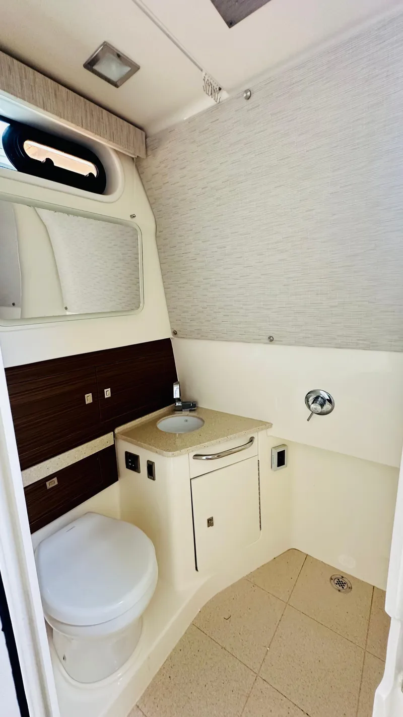 Slide: The Image of 2021 Boston Whaler 420 Outrage bathroom with modern fixtures and compact design. - 18