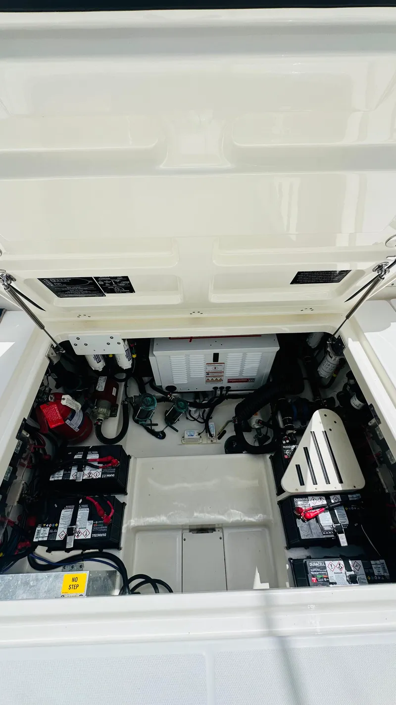 Slide: The Image of 2021 Boston Whaler 420 Outrage engine compartment with batteries and electrical components. - 3