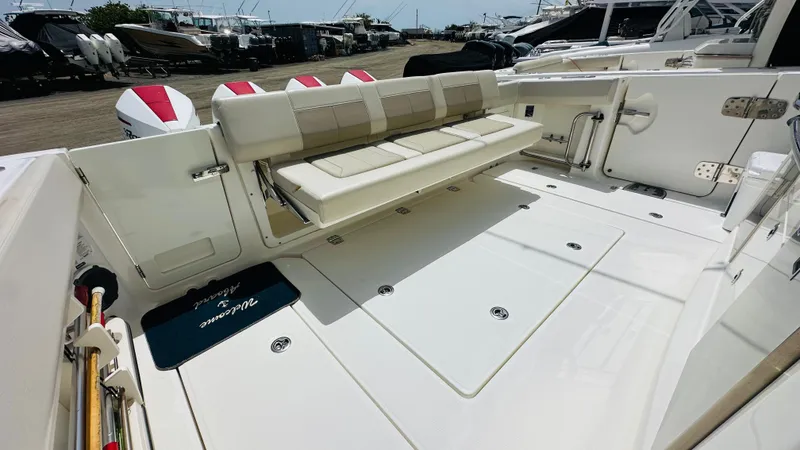 Slide: The Image of 2021 Boston Whaler 420 Outrage boat deck with seating and storage compartments. - 5