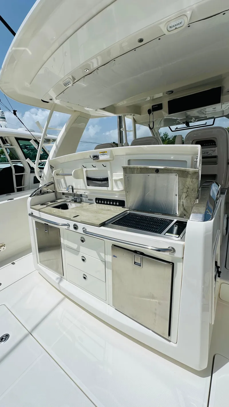 Slide: The Image of Boston Whaler 420 Outrage 2021 boat kitchen with grill and storage. - 7