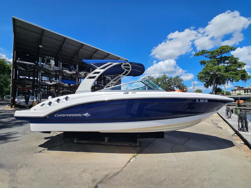Slide: The Image of 2017 Chaparral 246 SSi boat on display under a clear blue sky. - 15