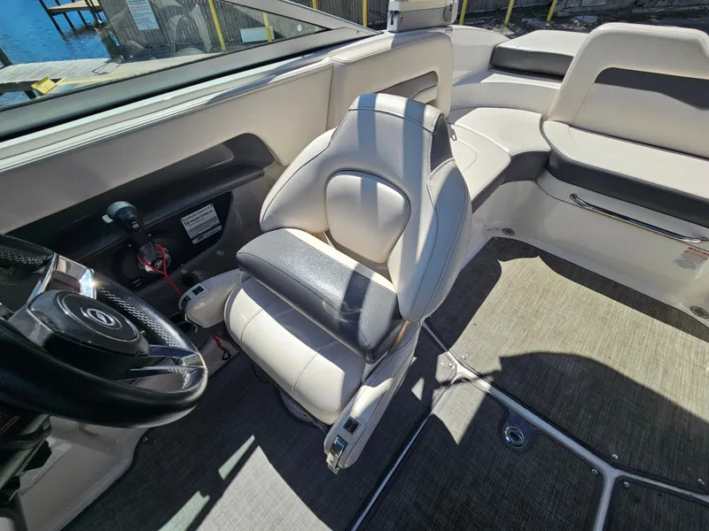 Slide: The Image of 2017 Chaparral 246 SSi boat interior with steering wheel and seating. - 21