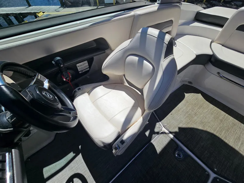 Slide: The Image of Interior of 2017 Chaparral 246 SSi boat with white seating and steering wheel. - 22