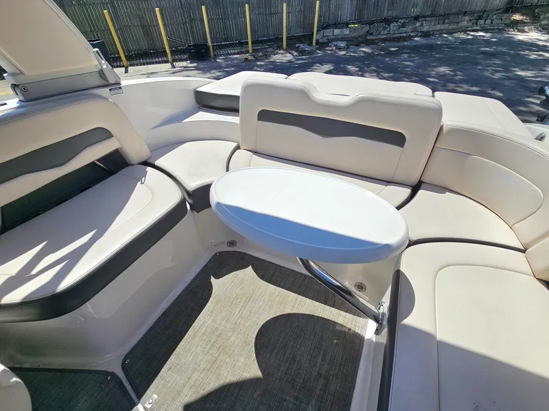 Slide: The Image of 2017 Chaparral 246 SSi boat interior with white seating and oval table. - 34