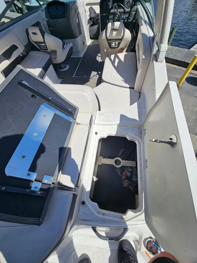 Slide: The Image of 2017 Chaparral 246 SSi boat interior with open storage compartments and seating. - 36