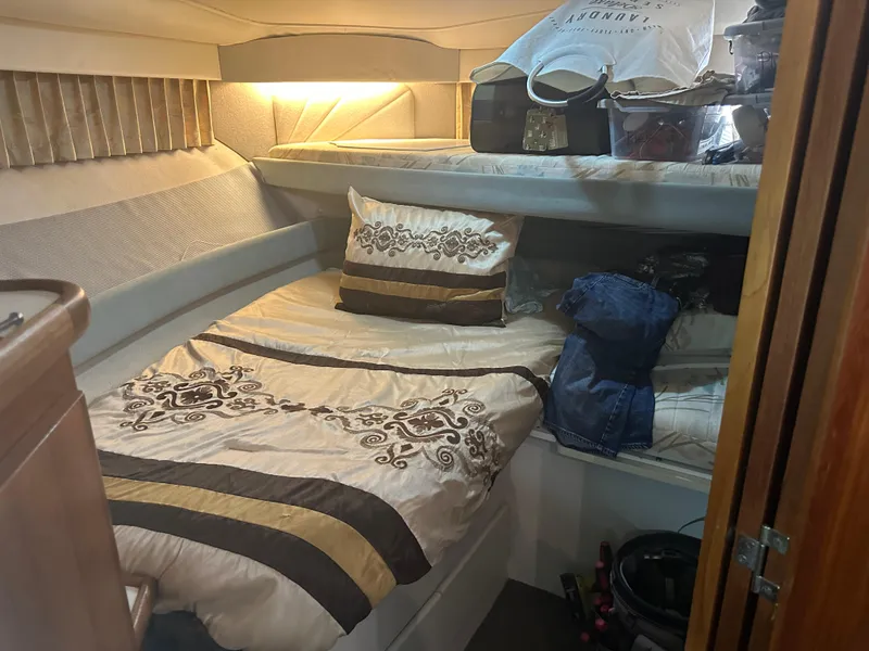 Slide: The Image of 1993 Carver 350 Aft Cabin interior with bed, storage, and decorative bedding. - 18