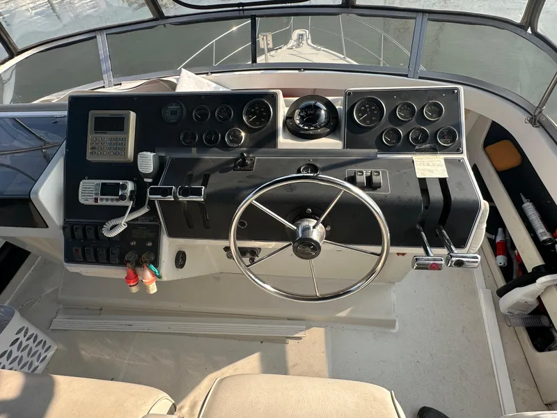 Slide: The Image of 1993 Carver 350 Aft Cabin helm with steering wheel and control panel. - 3