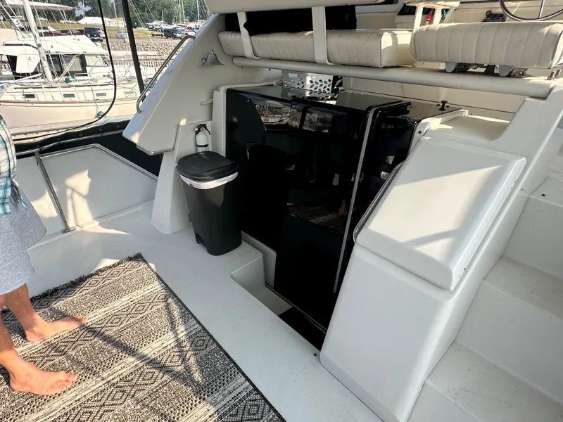 Slide: The Image of 1993 Carver 350 Aft Cabin interior with seating, rug, and trash bin. - 7