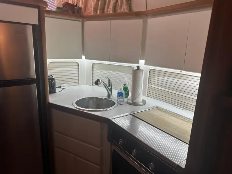 Slide: The Image of 1993 Carver 350 Aft Cabin kitchen with sink, stove, and modern appliances. - 13