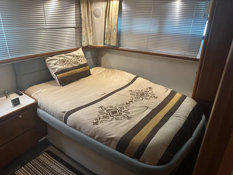 Slide: The Image of Cozy bedroom in 1993 Carver 350 Aft Cabin with elegant bedding and wood accents. - 14