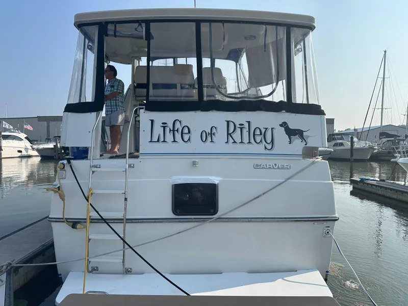 Slide: The Image of 1993 Carver 350 Aft Cabin yacht named "Life of Riley" docked at marina. - 2