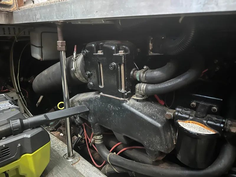 Slide: The Image of Engine compartment of a 1993 Carver 350 Aft Cabin boat, showing hoses and components. - 23