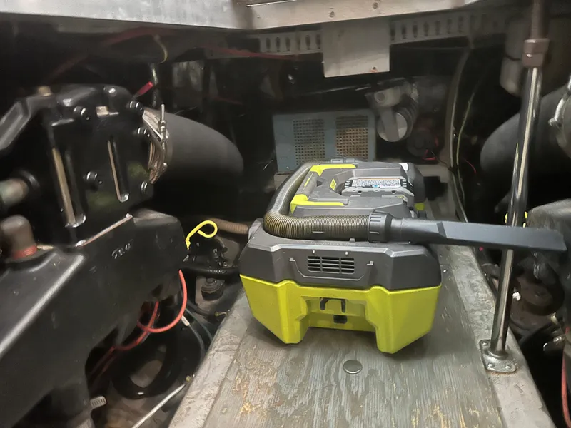 Slide: The Image of Engine room of 1993 Carver 350 Aft Cabin with a portable vacuum cleaner. - 24