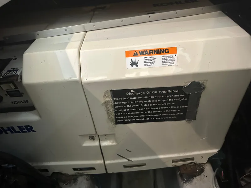 Slide: The Image of Engine compartment of 1993 Carver 350 Aft Cabin with warning labels and Kohler generator. - 25